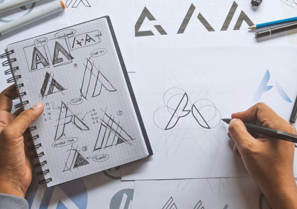 Graphic designer drawing sketch creative ideas draft logo